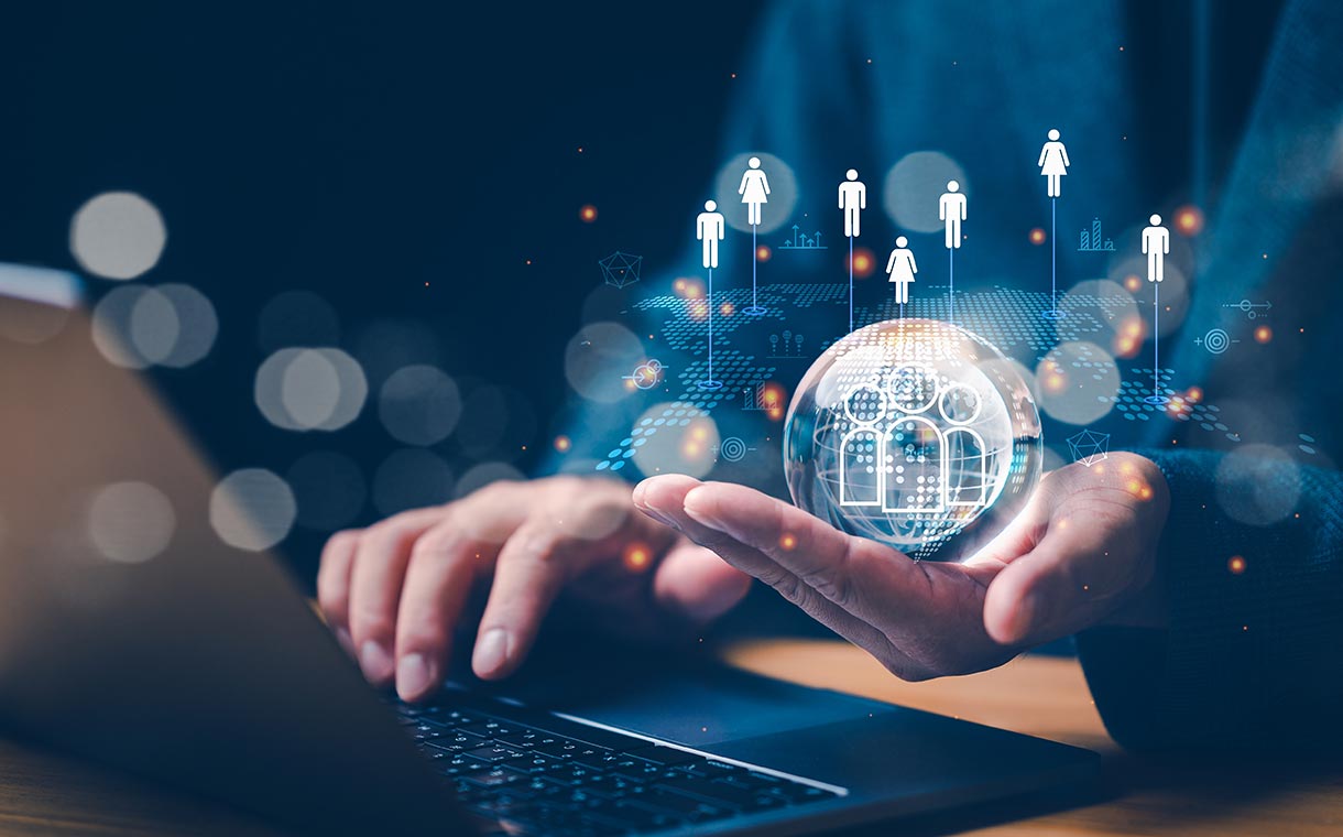A decorative image of one hand typing while the other holds a transparent ball containing a group of people; behind it, individual people emerge on a virtual circuit board. It represents how Zafin drives personalized services and offerings.