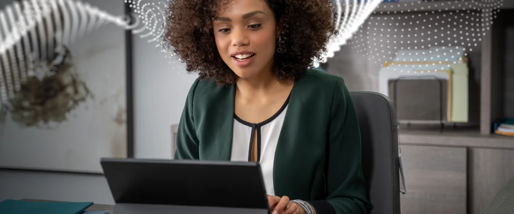 A decorative image ofa smiley woman using her laptop representing how the integration ofMicrosoft Cloud for Financial Services enhances customer and employee experiences